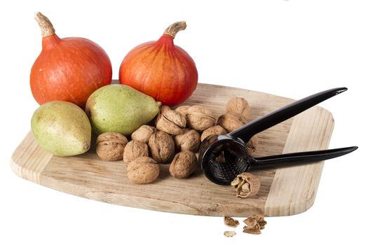 pear, pumpkin and many nuts isolated on white background with nutcracker