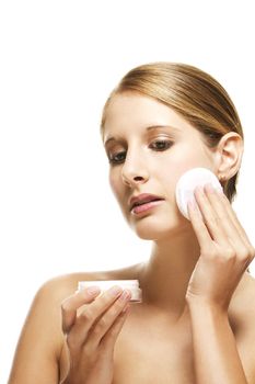 young woman applying makeup on white background