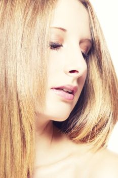 closeup portrait of a beautiful woman looking on side down