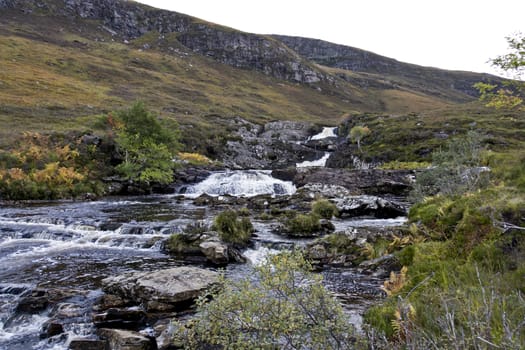 small river in scottish highlands flowing through heathland