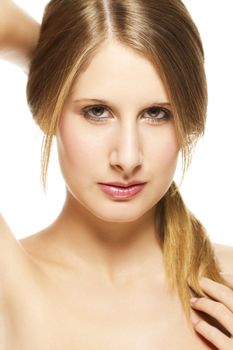 young beautiful woman holding her pigtail on white background