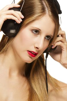 young beautiful blonde woman with headphones listening to music