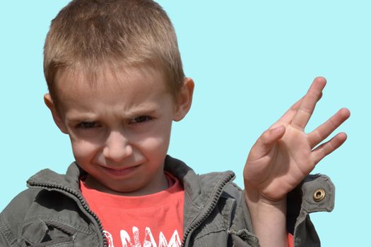 little boy twinkling and showing a gesture with his fingers