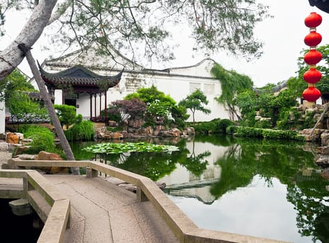 Chinese park in summer with red lanterns aside