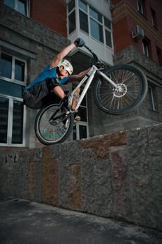 Biker standing on border after hard jump