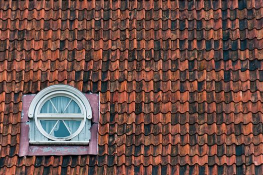 Scandinavian roof tiles texture with window in Tallinn, Estonia