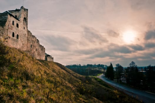Ruined castle on the hill at time of beautiful sunset