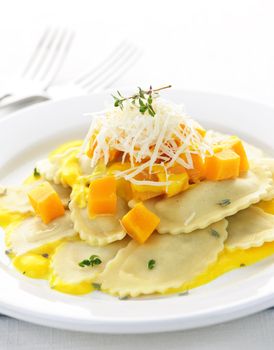 Gourmet squash ravioli dinner served with cheese on plate