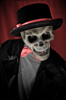 Skeleton in suite portrait on red background