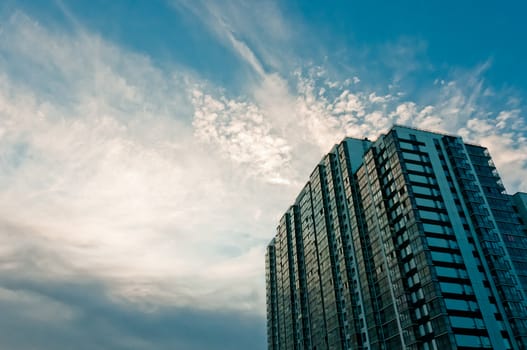 Cloudy, beautiful sky and high apartment house