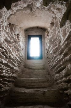 Window in scandinavian castle in the end of archway