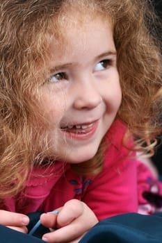 Beautiful young girl with curly hair and cute features
