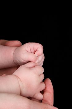 Caucasian mother and baby, baby holding mother's thumb 
