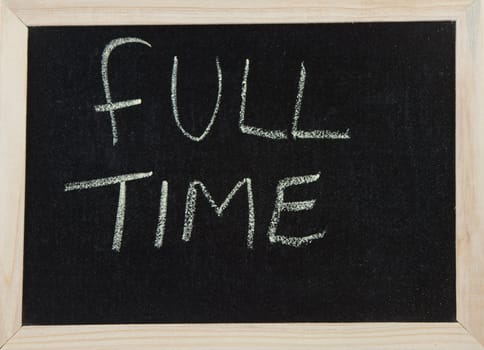 A black board with a wooden frame and the word 'FULL TIME' written in chalk.