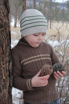 Warmly dressed boy playing outside in the snow