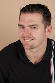 Young brunette male against a light background