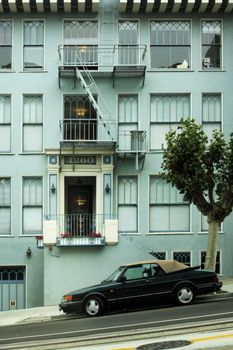 Facade of a green building and the automobile in the street in San Francisco