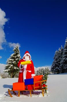 Santa Claus, Father Christmas with colorful presents on a sledge