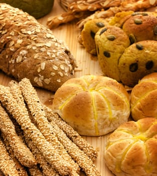 Variety of Organic Breads on plank background