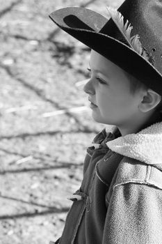 Young cowboy wearing a hat and fleece jacket