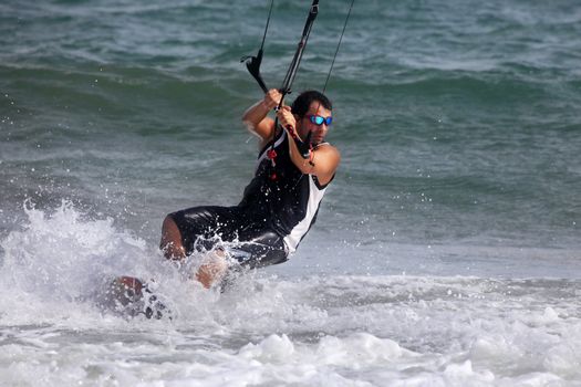 Kiteboarder enjoy surfing in ocean. Vietnam