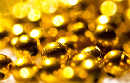 Golden beads background close up in landscape orientation