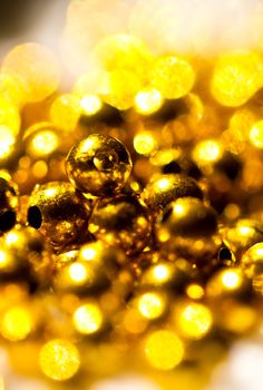 Golden colored beads shines under the sun can be use as background