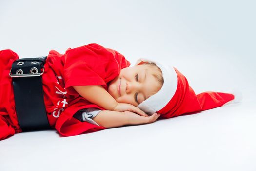 Cute Baby boy - little santa claus sleep. In studio