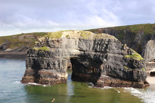 a canoeist at the virgin rock in ballybunion ireland as seen from the cliffs