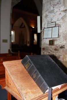 a bible on a stand in an old church
