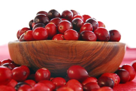 Fresh red cranberries in a wooden bowl