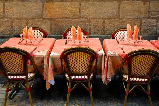 Outdoor restaurant patio on medieval street of Sarlat, Dordogne region, France