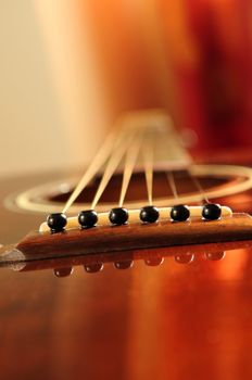 Acoustic guitar bridge and strings close up