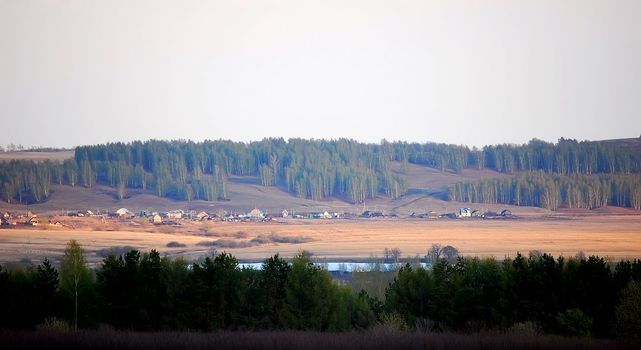 Village in wood at lake