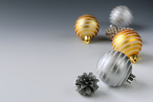 Christmas background with glass bauble ornaments and pine cones