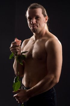 standing romantic man with pink rose
