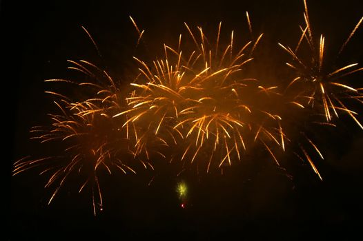golden fireworks exploding high in the sky 
