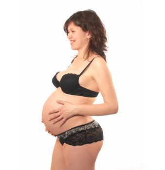 Portrait of the pregnant womanin a black bra