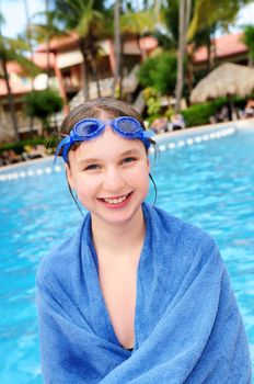 Teenage girl at the swimming pool in tropical resort