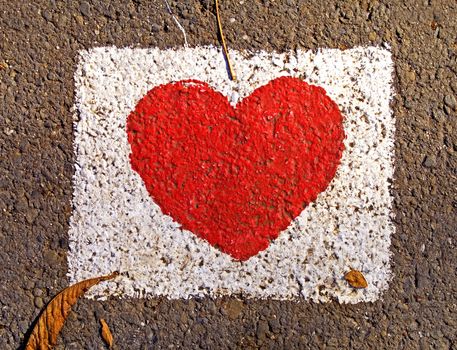 Red heart painted on the road