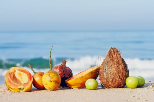 Exotic tropical fruit on the leaves plate on the sandy beach