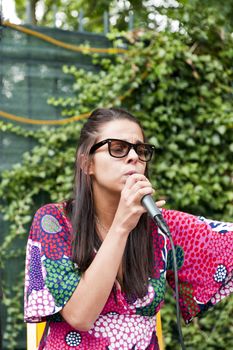 a young girl who is singing in the open air concert
