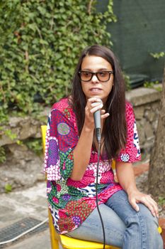 a young girl who is singing in the open air concert
