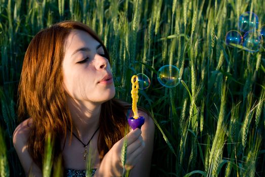 A young woman blowing bubbles