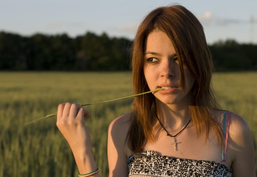 Girl and cereal crop in field