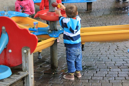Little boy at a very colored playground