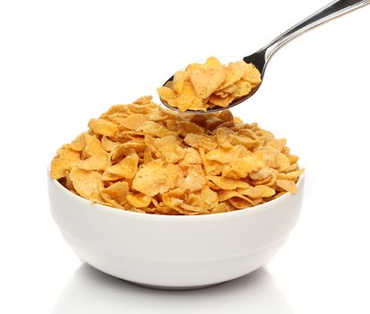 Cornflakes on a spoon over a bowl