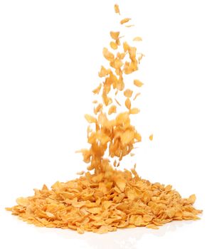 Cornflakes falling into a pile, over white background