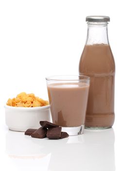 Chocolate milk and cornflakes over white background