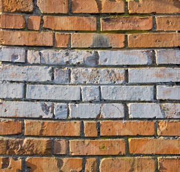 Wall made of red and colored bricks. Architectural decision.